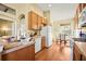 Well-lit kitchen featuring wood floors, modern appliances, and a cozy dining area with lots of light at 31108 Whitlock Dr, Wesley Chapel, FL 33543