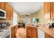 Kitchen flowing into living room, featuring stainless steel appliances and seamless design, great for gatherings at 31108 Whitlock Dr, Wesley Chapel, FL 33543