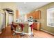 Open-concept kitchen with breakfast bar, stylish barstools, and wood floors creating an inviting space at 31108 Whitlock Dr, Wesley Chapel, FL 33543