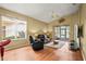 Bright living room with vaulted ceilings, neutral paint, and a sliding glass door leading to a screened lanai at 31108 Whitlock Dr, Wesley Chapel, FL 33543