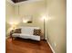 Inviting living room featuring a futon with patterned pillows and hardwood flooring at 31108 Whitlock Dr, Wesley Chapel, FL 33543