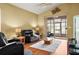 Inviting living room with vaulted ceilings, sliding glass doors to the lanai, and wood-style flooring at 31108 Whitlock Dr, Wesley Chapel, FL 33543