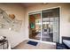 Outdoor patio with a sliding glass door leading to the interior, decorated with nautical-themed ornaments at 31108 Whitlock Dr, Wesley Chapel, FL 33543