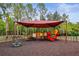 A colorful playground under a shade structure provides hours of fun for children at 31108 Whitlock Dr, Wesley Chapel, FL 33543
