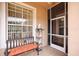 Inviting screened porch with bench seating and charming decor, creating a cozy outdoor space at 31108 Whitlock Dr, Wesley Chapel, FL 33543