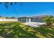 Spacious backyard features a concrete patio and a well-maintained lawn with a white fence at 315 Dorchester Dr, Venice, FL 34293
