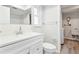 Clean bathroom with a white vanity, toilet, and a shower/tub combination beneath a window at 315 Dorchester Dr, Venice, FL 34293