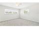 Inviting bedroom features plush carpeting, a ceiling fan, and dual windows, providing ample natural light at 315 Dorchester Dr, Venice, FL 34293