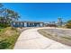 Charming single-story home with well-maintained landscaping and a long driveway leading to the front door at 315 Dorchester Dr, Venice, FL 34293