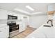 Well-lit kitchen with sleek white cabinetry, stainless steel appliances, and quartz countertops, offering a clean and modern feel at 315 Dorchester Dr, Venice, FL 34293