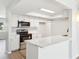 Bright kitchen featuring a breakfast bar, stainless steel appliances, and white cabinets, ideal for everyday living at 315 Dorchester Dr, Venice, FL 34293