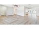 Open-concept living area featuring laminate floors and seamless transitions to the dining area and kitchen at 315 Dorchester Dr, Venice, FL 34293