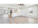 Open living space with a view of the kitchen, complete with modern flooring and a ceiling fan for added comfort at 315 Dorchester Dr, Venice, FL 34293