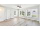 Bright living room featuring a ceiling fan and large windows, providing ample natural light and a welcoming atmosphere at 315 Dorchester Dr, Venice, FL 34293