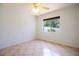 Bright bedroom with tile flooring and a window offering ample natural light and a view of the greenery outside at 3201 Pine Top Dr, Valrico, FL 33594