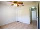 This bedroom boasts tile flooring, a ceiling fan, and a closet, offering ample storage and comfort at 3201 Pine Top Dr, Valrico, FL 33594
