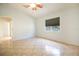 Cozy bedroom featuring tile floors, a ceiling fan, and a large window at 3201 Pine Top Dr, Valrico, FL 33594