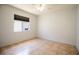 Neutral bedroom with tile flooring and a window that provides natural light and a view to the outside at 3201 Pine Top Dr, Valrico, FL 33594