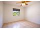 Bright bedroom features neutral walls, tile flooring, and a window offering natural light and outdoor views at 3201 Pine Top Dr, Valrico, FL 33594