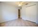 This bedroom showcases tile floors, a ceiling fan, a closet and a view to the entryway at 3201 Pine Top Dr, Valrico, FL 33594
