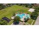 Aerial view of community pool featuring ample seating, a hot tub, and playground at 3201 Pine Top Dr, Valrico, FL 33594