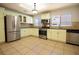 A functional kitchen featuring stainless steel appliances, tile flooring, and lots of natural light at 3201 Pine Top Dr, Valrico, FL 33594