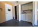 Bright laundry room with washer, dryer, storage cabinets, and access door to additional space at 3201 Pine Top Dr, Valrico, FL 33594