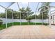 Expansive screened-in patio overlooking a lush, fenced backyard, perfect for enjoying outdoor living and entertainment at 3201 Pine Top Dr, Valrico, FL 33594