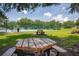 Community picnic area with tables in a grassy yard overlooking the basketball court at 3201 Pine Top Dr, Valrico, FL 33594