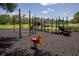 Outdoor playground featuring multiple structures and a soft rubber surface at 3201 Pine Top Dr, Valrico, FL 33594