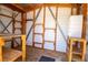 Interior view of shed, featuring wooden support beams and shelving for ample storage at 3201 Pine Top Dr, Valrico, FL 33594