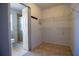 Spacious walk-in closet with wire shelving, ceramic tile floors, and close proximity to the bathroom at 3201 Pine Top Dr, Valrico, FL 33594