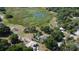 Overhead image showcasing the property with scenic views of the tranquil surrounding landscape and nearby bodies of water at 34389 Orchid Pkwy, Ridge Manor, FL 33523