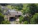 An aerial view of the property, featuring a pool, lush greenery, and a serene, natural backdrop at 34389 Orchid Pkwy, Ridge Manor, FL 33523