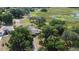 A bird's eye view of the property with lush trees and landscaping, highlighting the home's serene natural surroundings at 34389 Orchid Pkwy, Ridge Manor, FL 33523