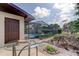 Backyard view with a screened-in pool area and a well-maintained yard, perfect for outdoor activities at 34389 Orchid Pkwy, Ridge Manor, FL 33523