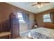 Bedroom with neutral walls, and natural light with a ceiling fan and warm hardwood flooring at 34389 Orchid Pkwy, Ridge Manor, FL 33523