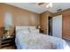 A serene bedroom with a plush bed, wooden floors and bright natural light filtering in through the window at 34389 Orchid Pkwy, Ridge Manor, FL 33523