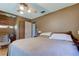 Bedroom featuring warm paint, wooden floors, and a ceiling fan with plenty of storage space at 34389 Orchid Pkwy, Ridge Manor, FL 33523