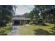 A charming single-story home with a well-maintained front yard and an attached garage, framed by mature trees at 34389 Orchid Pkwy, Ridge Manor, FL 33523