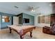 Spacious recreation room with a pool table, media center, and comfortable seating at 34389 Orchid Pkwy, Ridge Manor, FL 33523