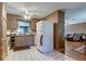 Modest kitchen with neutral-toned cabinetry, ceiling fan, and access to living areas at 34389 Orchid Pkwy, Ridge Manor, FL 33523