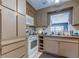 Practical kitchen featuring tiled countertops, white appliances, and ample cabinet space at 34389 Orchid Pkwy, Ridge Manor, FL 33523