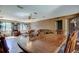 Inviting living room featuring hardwood floors, a ceiling fan, and large windows at 34389 Orchid Pkwy, Ridge Manor, FL 33523