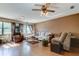 Bright living area with hardwood floors, large windows, and a comfortable seating area at 34389 Orchid Pkwy, Ridge Manor, FL 33523