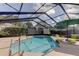 Sparkling screened-in pool offering a refreshing escape with lounge seating and open sky views at 34389 Orchid Pkwy, Ridge Manor, FL 33523