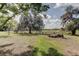 Expansive property featuring mature trees, open green spaces, and natural landscapes under a sunny sky with scattered clouds at 34389 Orchid Pkwy, Ridge Manor, FL 33523