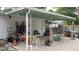 Backyard patio area with an overhead covering and ample seating at 406 2Nd Sw St, Ruskin, FL 33570
