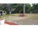 Large backyard featuring a tree swing, ample space, and privacy for relaxation and recreation at 406 2Nd Sw St, Ruskin, FL 33570