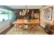 Inviting dining room with wood paneling, stylish decor, and a large window for natural light at 406 2Nd Sw St, Ruskin, FL 33570